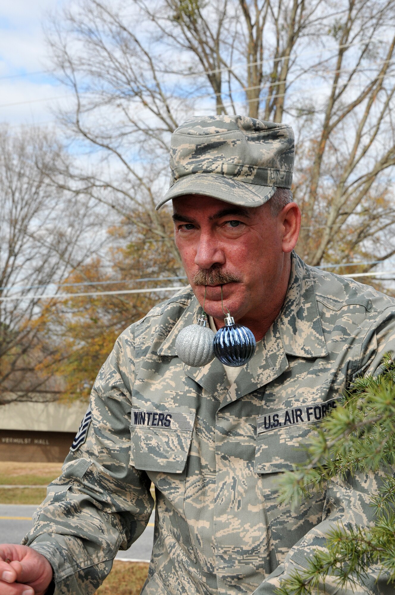 Master Sgt. Stephen Winters, 94th Force Support Squadron first sergeant, shows us his preferred way of toting decorations to the base holiday tree. Members of the First Four, on behalf of Chief Master Sgt. Wendell Peacock, 94th Airlift Wing command chief, invited Dobbins Air Reserve Base personnel out to decorate the base holiday tree near the front gate, Nov. 30.(U.S. Air Force photo/Senior Airman Elizabeth Van Patten)