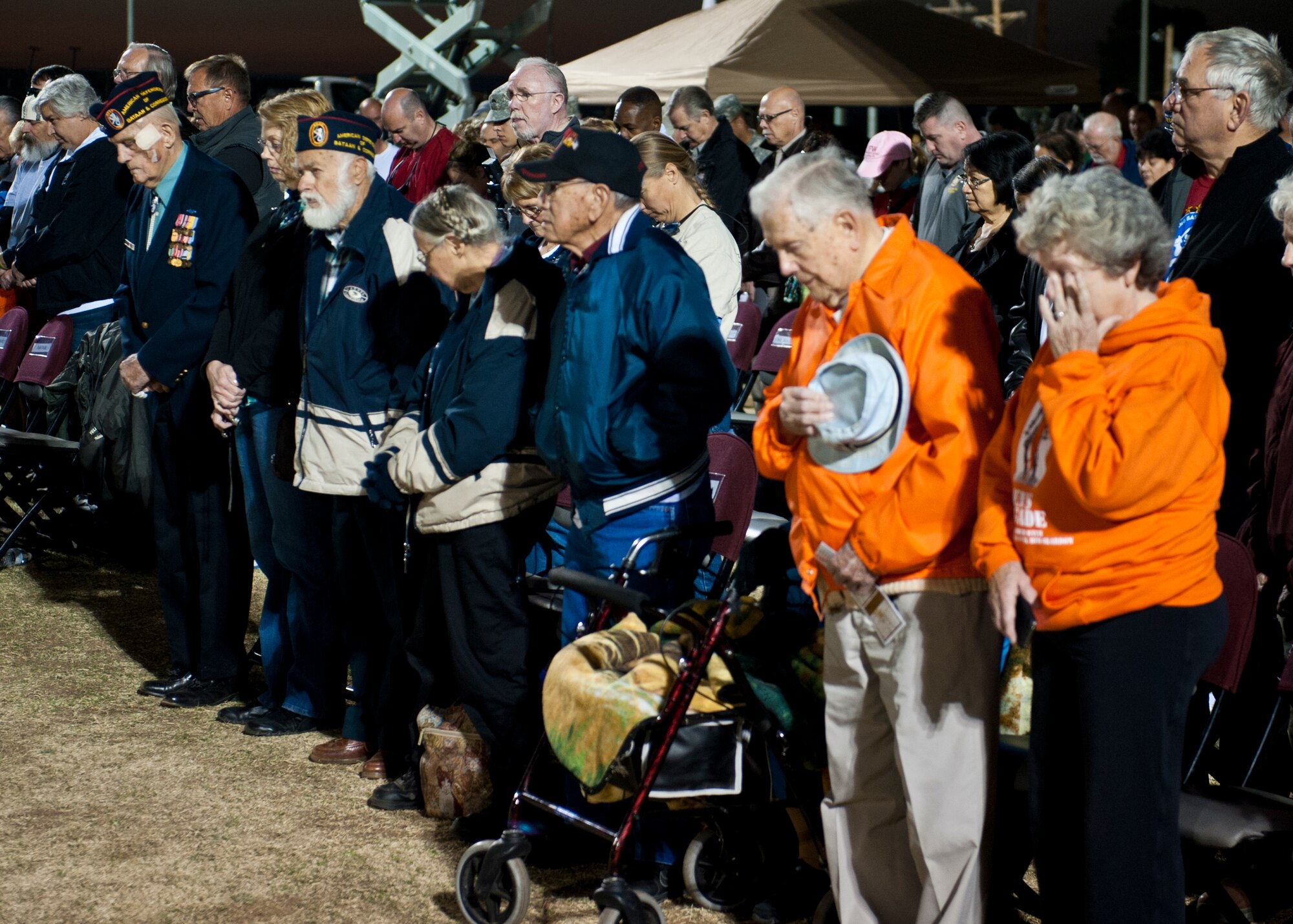 World War II veterans and their families stand as they are honored during the opening ceremony of the 24th annual Bataan Memorial Death March at White Sands Missile Range, N.M., March 17. More than 5,800 people who were from across the world participated in the 26.2-milememorial marathon to honor the 76,000 prisoners of war forced to endure marching nearly 80 miles under brutal conditions during World War II.  Many of the survivors return year after year to participate in the event and shake the hands with those who finish the 26-mile loop through the desert.  (U.S.  Air Force photo by Airman 1st Class Daniel E. Liddicoet/Released)
