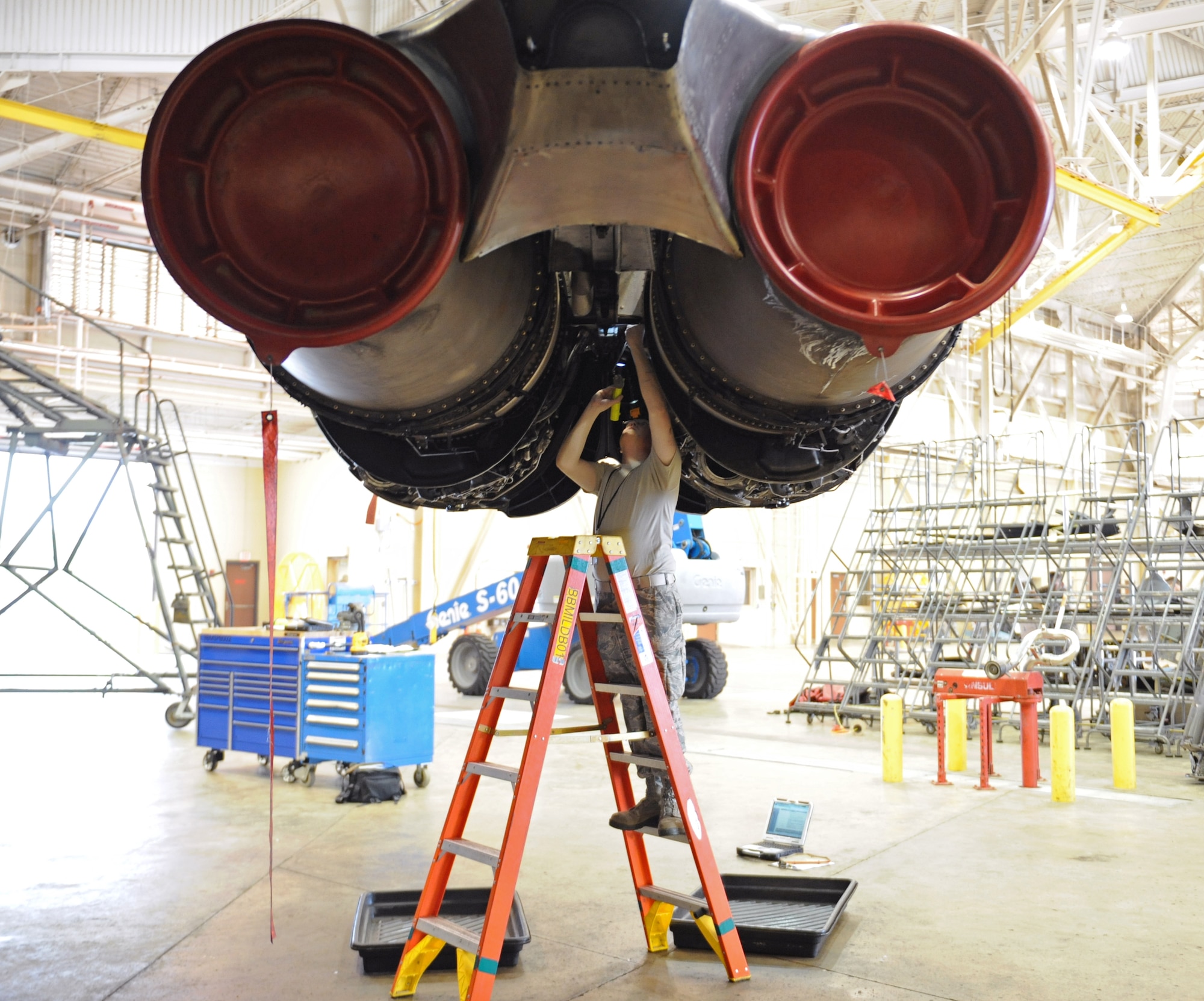 Airman Jesse Childress, 2nd Maintenance Squadron Accessories Flight Electrical and Environmental Section, inspect the bottom of a B-52H Stratofortress engine on Barksdale Air Force Base, La., March 18. Electrical and Environmental Airmen search for worn wires and replace them if necessary. They perform a general assessment of the aircraft's systems to ensure they are operating properly. (U.S. Air Force photo/Airman 1st Class Benjamin Gonsier)