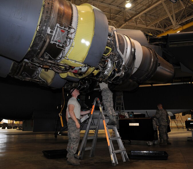 Maintainers from the 2nd Maintenance Squadron Accessories Flight Electrical and Environmental Section, conduct a bottom of pod inspection on a B-52H Stratofortress on Barksdale Air Force Base, La., March 18. During a bottom of pod inspection, the maintainers check for any parts that are shaved, bent, cracked or dented under the B-52 engine. (U.S. Air Force photo/Airman 1st Class Benjamin Gonsier)