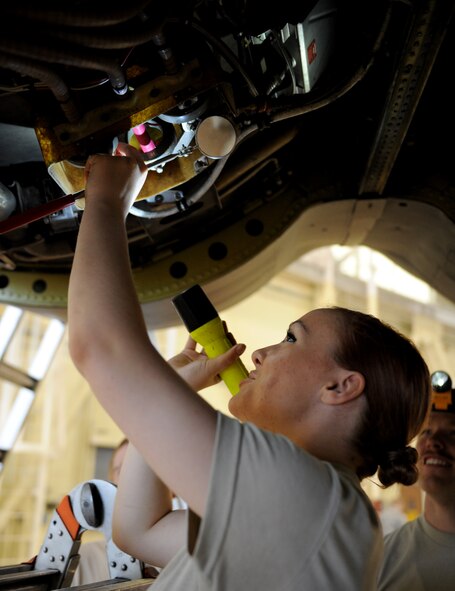 Airman 1st Class Kristen McConnell, 2nd Maintenance Squadron Accessories Flight Electrical and Environmental Section, conducts a bottom of pod inspection on a B-52H Stratofortress on Barksdale Air Force Base, La., March 18. During a bottom of pod inspection, the maintainers check for any parts that are shaved, bent, cracked or dented under the B-52 engine. (U.S. Air Force photo/Airman 1st Class Benjamin Gonsier)