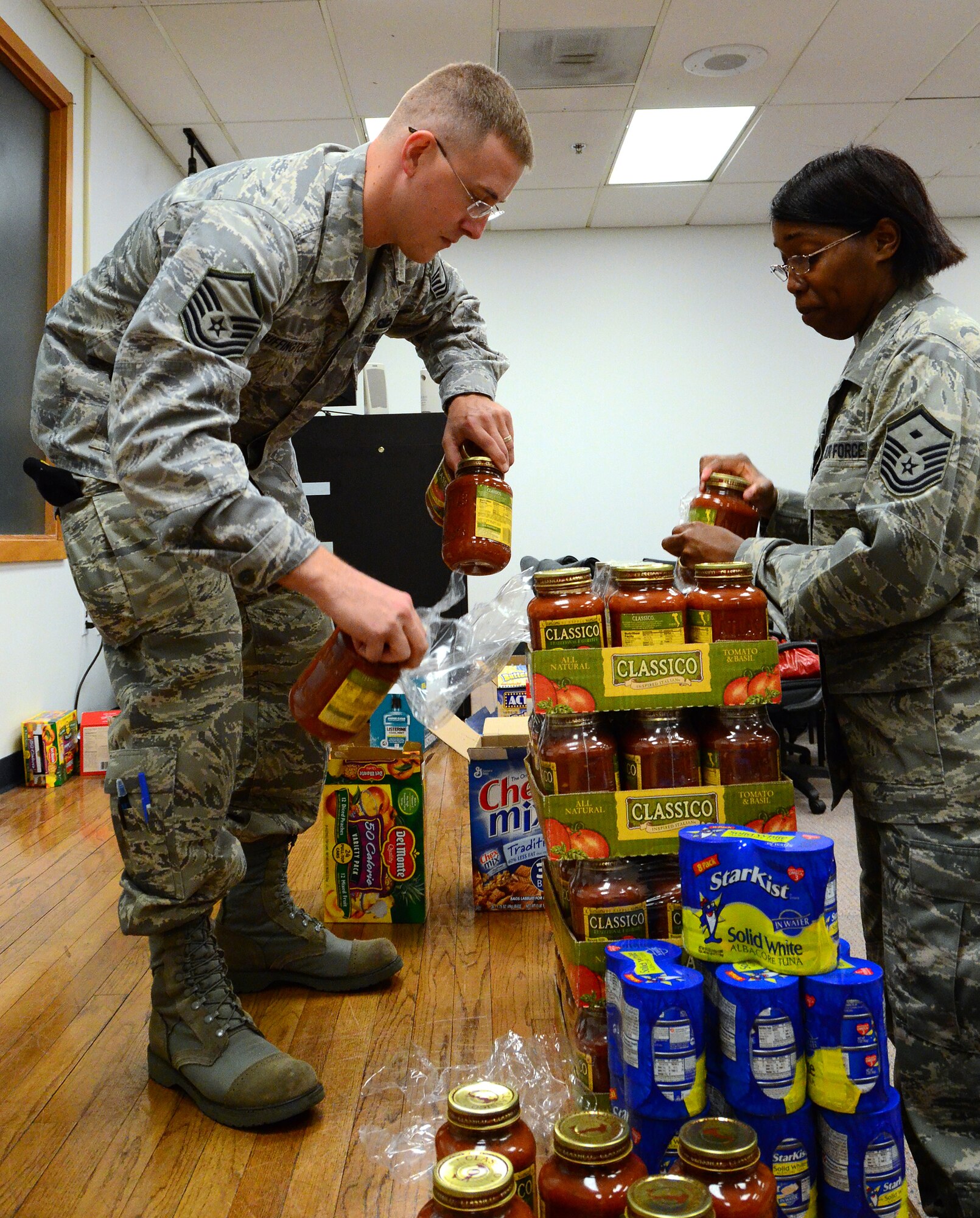 Members of the Dobbins First Sergeants Council, Dobbins Human Resource Development Council, the Lonely Hearts Club and Military Order of the Purple Heart -Chapter 576 met on Dec. 5 to assemble baskets of holiday food for Airmen in need at Dobbins Air Reserve Base. (U.S. Air Force photo/Senior Airman Elizabeth Van Patten)