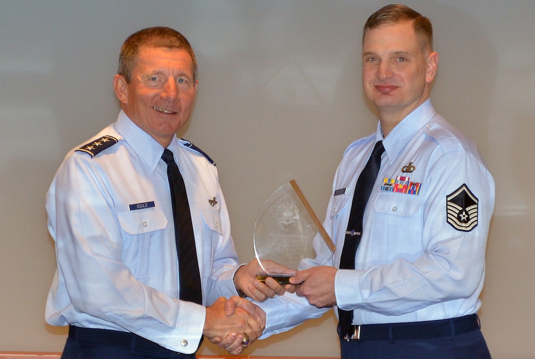 Master Sergeant Gene Montgomery receives the 2012 USAF Academy Resource Manager of the year from General Mike Gould, Superintendent, United States Air Force Academy. (U.S. Air Force photo/CMSgt John Gohl)