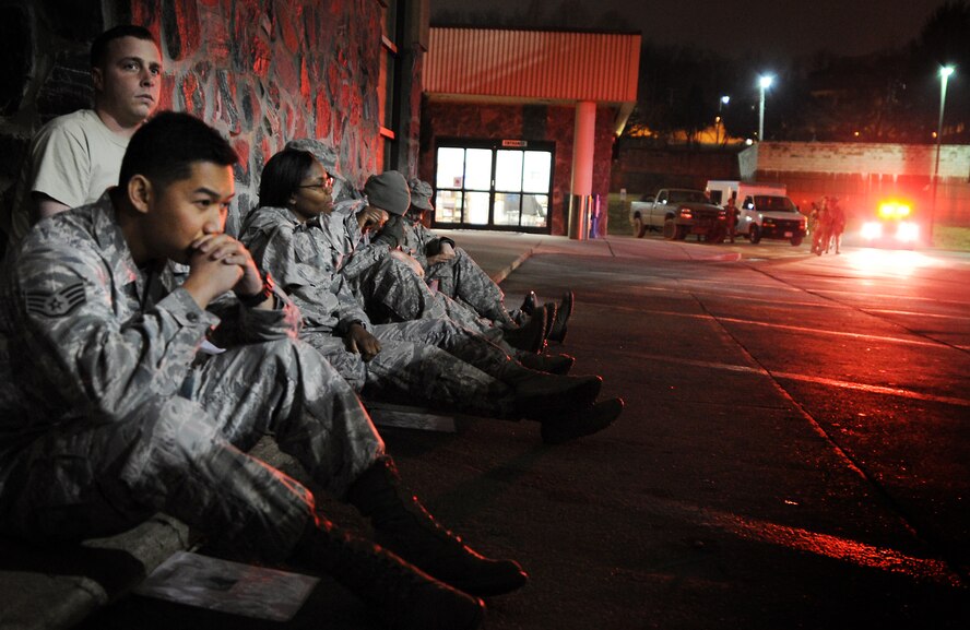 Simulated victims of a bus accident wait for assistance from 51st Medical Group personnel during Operation Readiness Exercise Beverly Midnight 13-02 at Osan Air Base, Republic of Korea, March 18, 2013. Osan Airmen are in the third simulated wartime contingency exercise executed in 2013 that will test the base's ability to defend and execute the mission in a heightened state of readiness. (U.S. Air Force photo/Staff Sgt. Sara Csurilla)