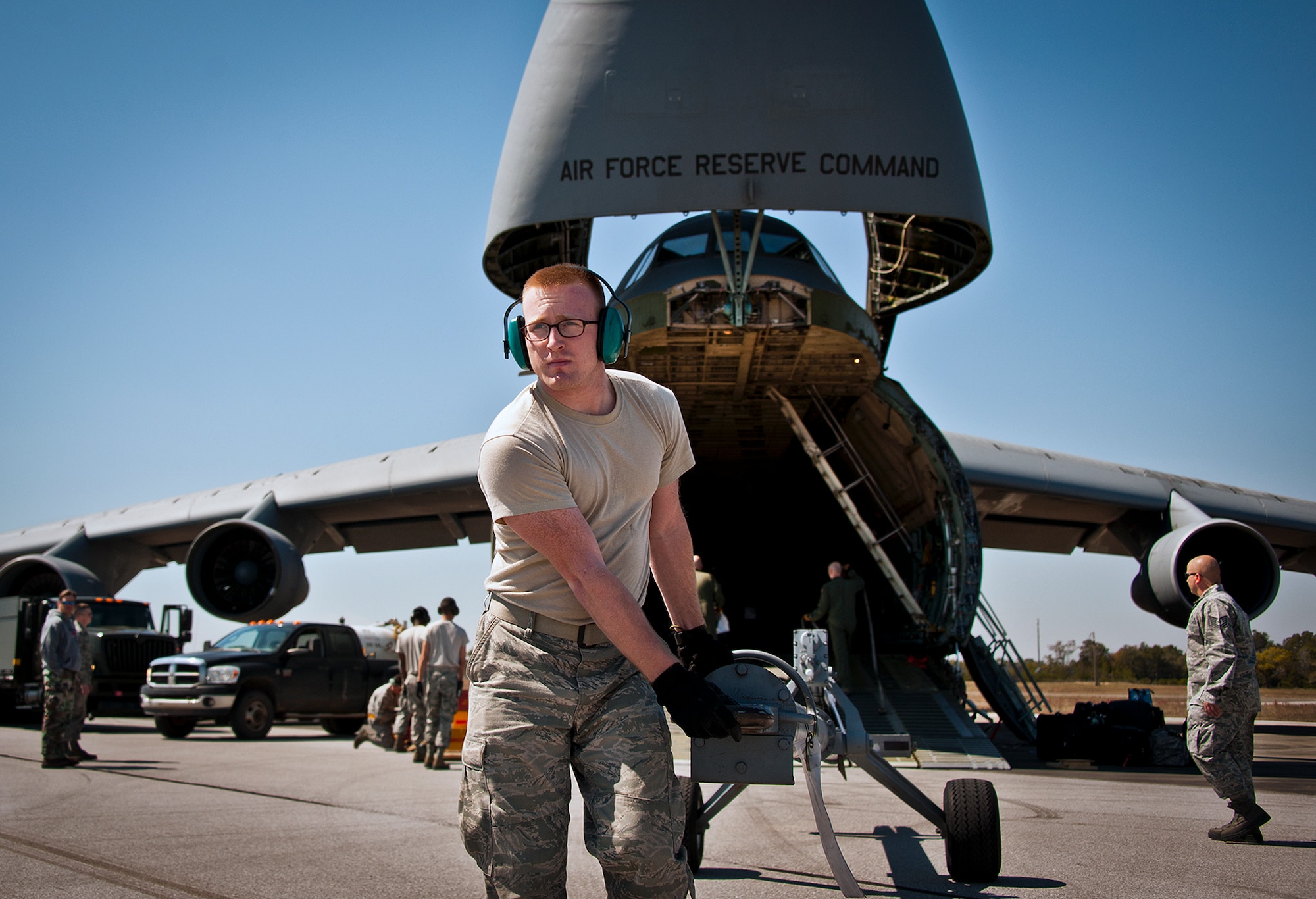 Senior Airman Kalipb Wiggins, of the 96th Logistics Readiness Squadron, moves a piece of equipment away from a C-5 Galaxy March 14 at Eglin Air Force Base, Fla.  The Airmen unloaded approximately 103,165 pounds of maintenance equipment for an F-16 unit participating in a weapons system evaluation program the following week.  (U.S. Air Force photo/Samuel King Jr.)
