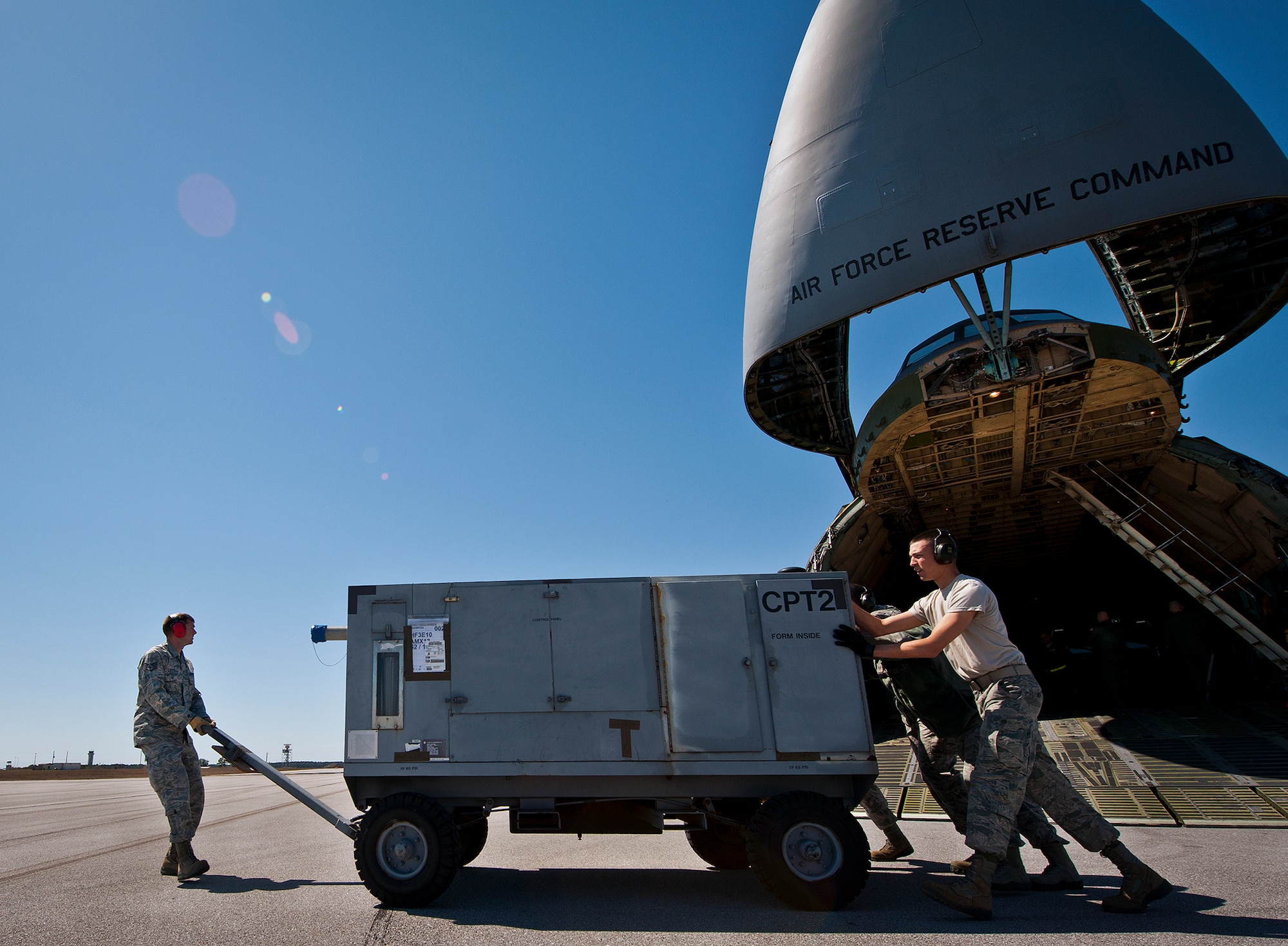 Staff Sgt. Darryl Leytham and Airman 1st Class Josh Wilson, of the 96th Logistics Readiness Squadron, move a generator away from a C-5 Galaxy March 14 at Eglin Air Force Base, Fla.  The Airmen unloaded approximately 103,165 pounds of maintenance equipment for an F-16 unit participating in a weapons system evaluation program March 18-22.  (U.S. Air Force photo/Samuel King Jr.)