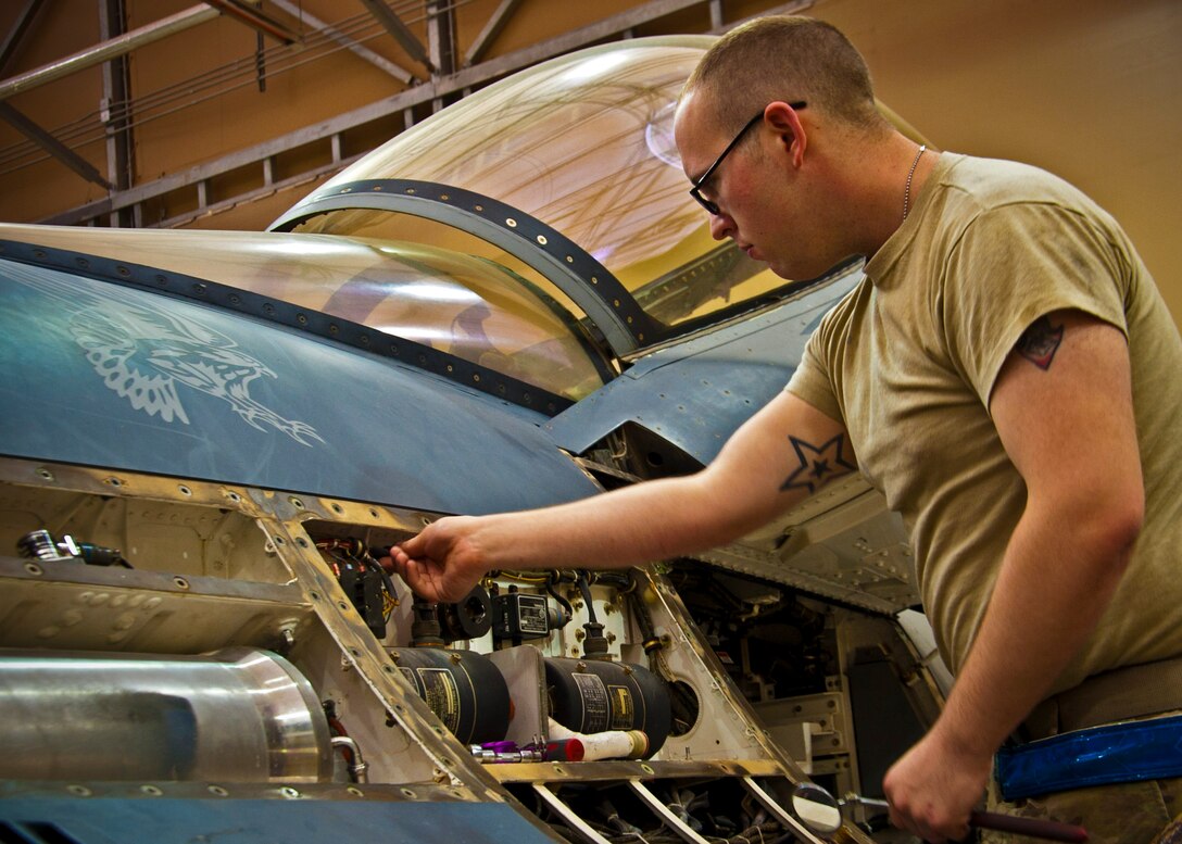 An Airman with the 451st Expeditionary Maintenance Squadron inspects an F-16 Fighting Falcon during a 400-flight-hour phase inspection at Kandahar Airfield, Afghanistan, Feb. 26, 2013. The 451st inspects everything on the aircraft from leaks or cracks to anything that may jeopardize the integrity of the aircraft. (U.S. Air Force photo/Senior Airman Scott Saldukas)