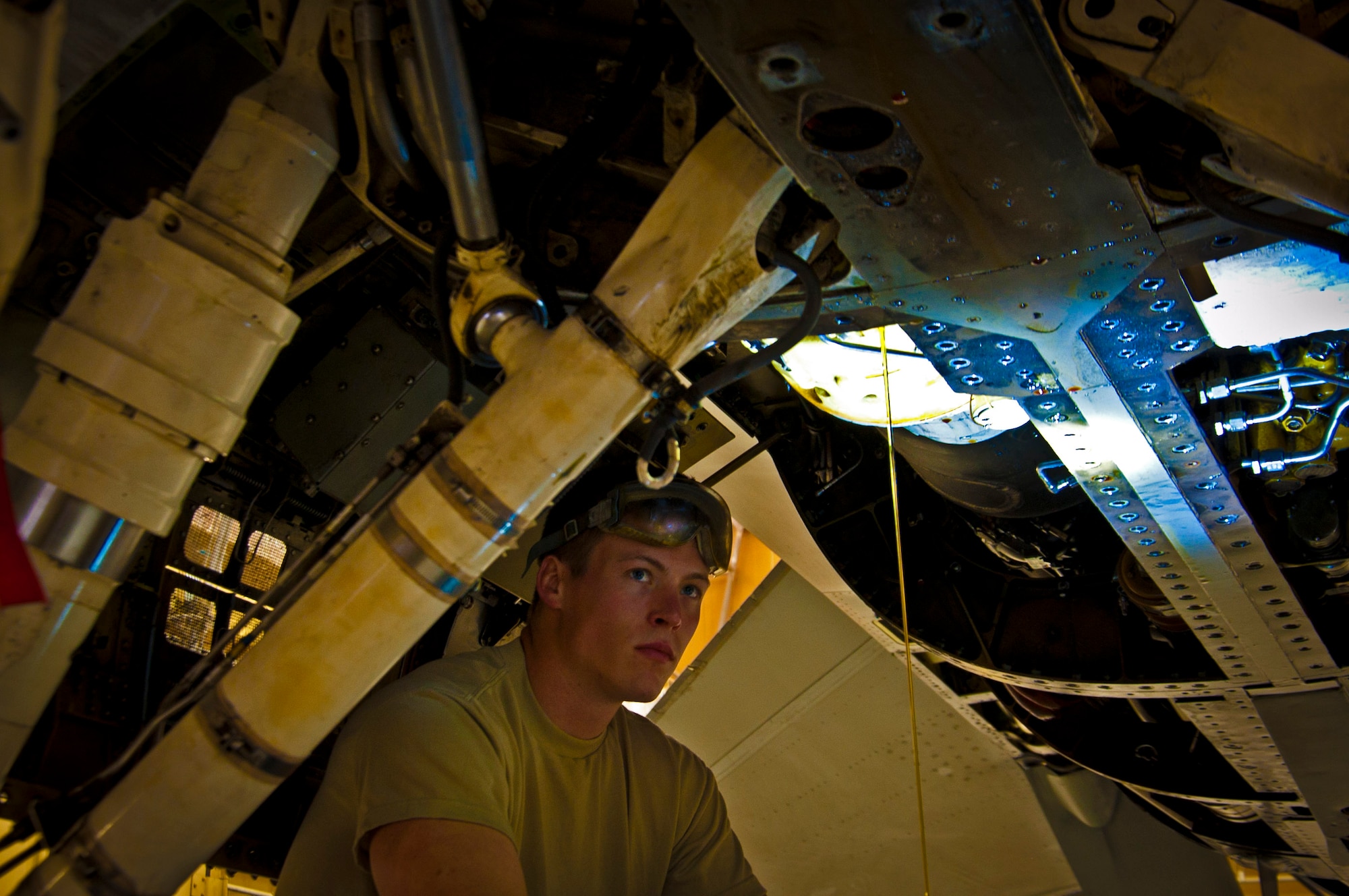 Senior Airman Matthew Walschinski, 451st Expeditionary Maintenance Squadron aircraft maintainer, watches as oil drains from an F-16 Fighting Falcon during a 400-flight-hour phase inspection at Kandahar Airfield, Afghanistan, Feb. 26, 2013. The 451st inspects everything on the aircraft from leaks or cracks to anything that may jeopardize the integrity of the aircraft. (U.S. Air Force photo/Senior Airman Scott Saldukas)