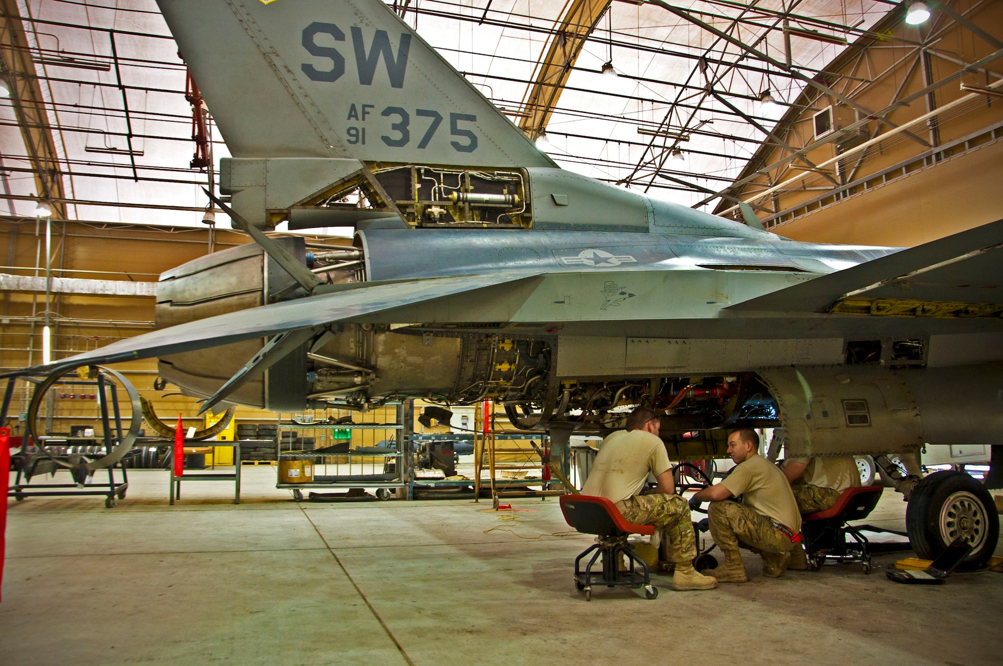 Airmen with the 451st Expeditionary Maintenance Squadron discuss what to do next as they inspect an F-16 Fighting Falcon during a 400-flight-hour phase inspection at Kandahar Airfield, Afghanistan, Feb. 26, 2013. The 451st inspects everything on the aircraft from leaks or cracks to anything that may jeopardize the integrity of the aircraft. (U.S. Air Force photo/Senior Airman Scott Saldukas)