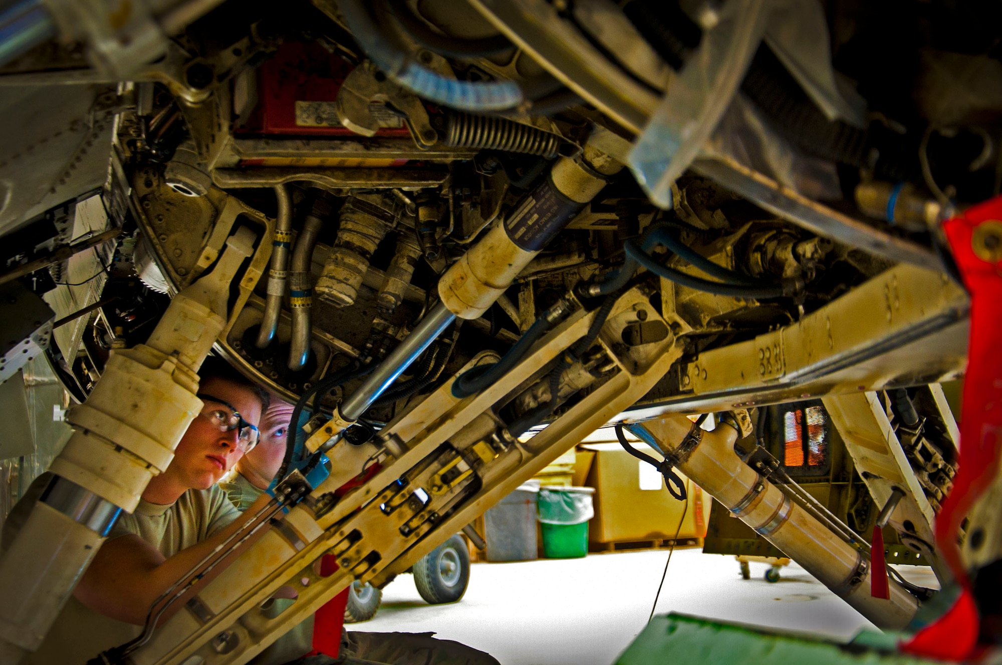 Senior Airman Matthew Walschinski, 451st Expeditionary Maintenance Squadron aircraft maintainer, inspects the underbelly of an F-16 Fighting Falcon during a 400-flight-hour phase inspection at Kandahar Airfield, Afghanistan, Feb. 26, 2013. The 451st inspects everything on the aircraft from leaks or cracks to anything that may jeopardize the integrity of the aircraft. (U.S. Air Force photo/Senior Airman Scott Saldukas)