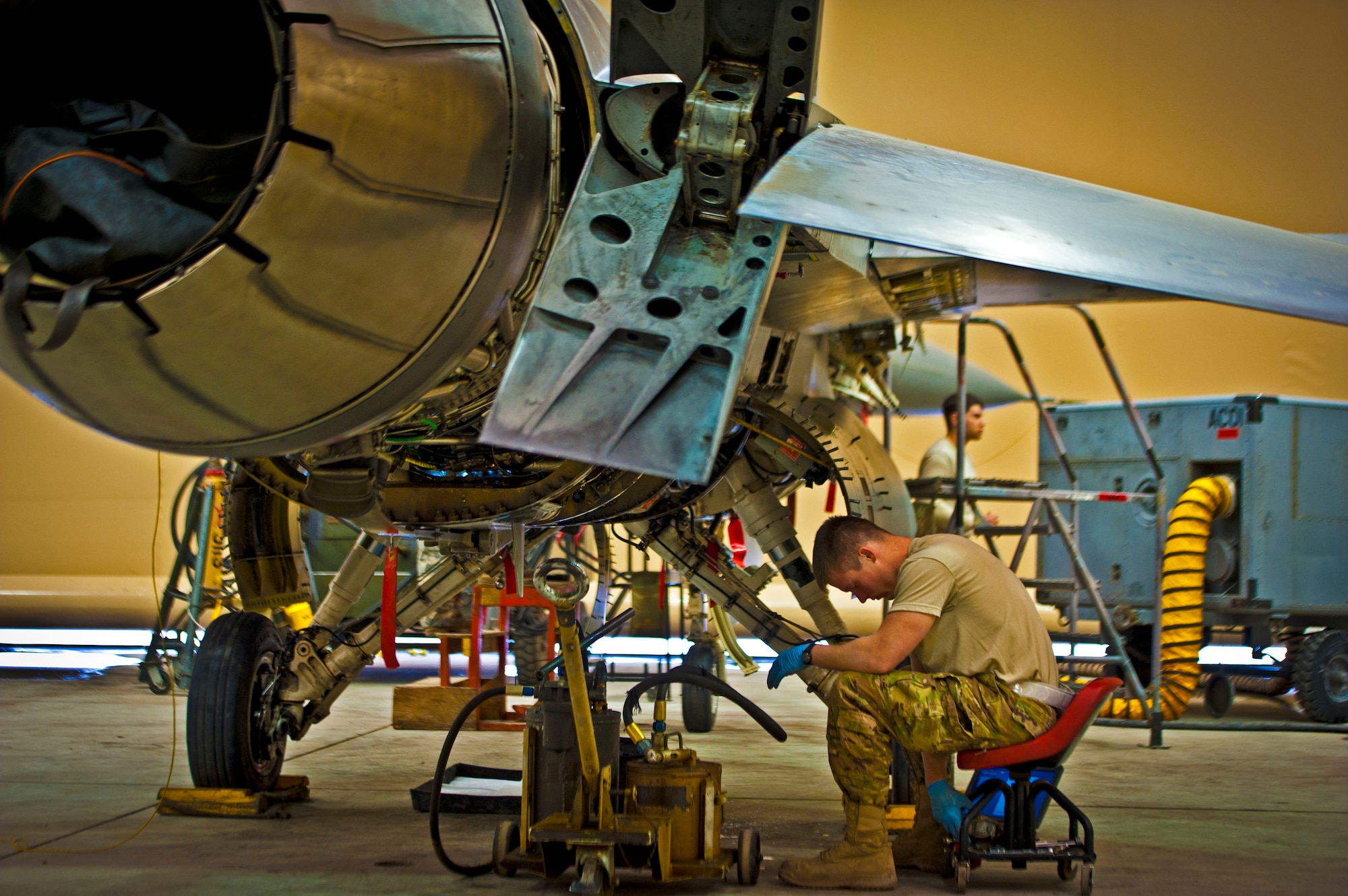 Senior Airman Matthew Walschinski, 451st Expeditionary Maintenance Squadron aircraft maintainer, grabs a tool during a 400-flight-hour phase inspection on an F-16 Fighting Falcon at Kandahar Airfield, Afghanistan, Feb. 26, 2013. The 451st inspects everything on the aircraft from leaks or cracks to anything that may jeopardize the integrity of the aircraft. (U.S. Air Force photo/Senior Airman Scott Saldukas)