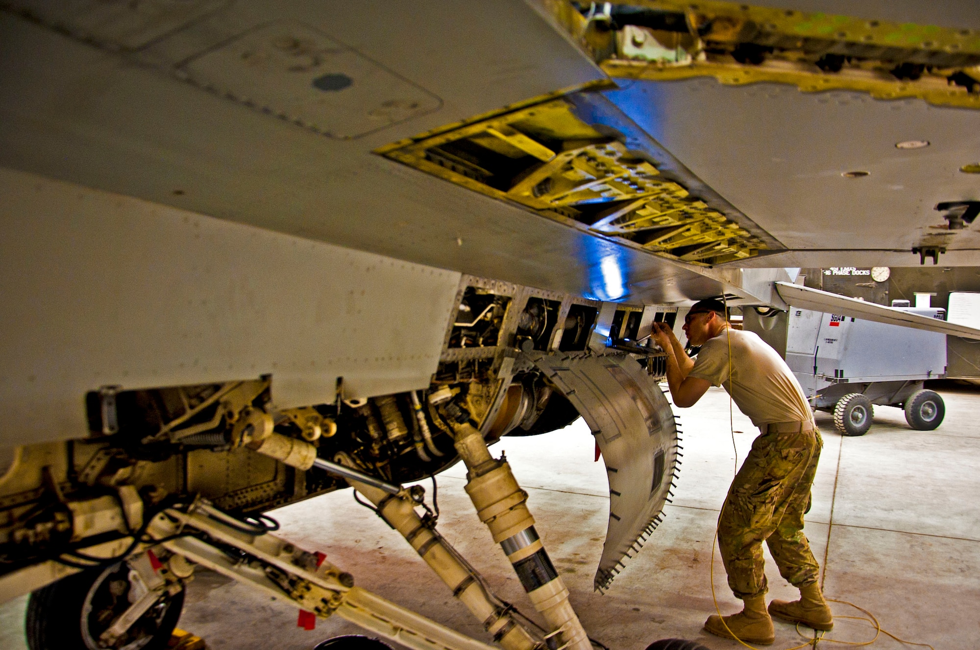 An Airman with the 451st Expeditionary Maintenance Squadron inspects an F-16 Fighting Falcon during a 400-flight-hour phase inspection at Kandahar Airfield, Afghanistan, Feb. 26, 2013. The 451st inspects everything on the aircraft from leaks or cracks to anything that may jeopardize the integrity of the aircraft. (U.S. Air Force photo/Senior Airman Scott Saldukas)
