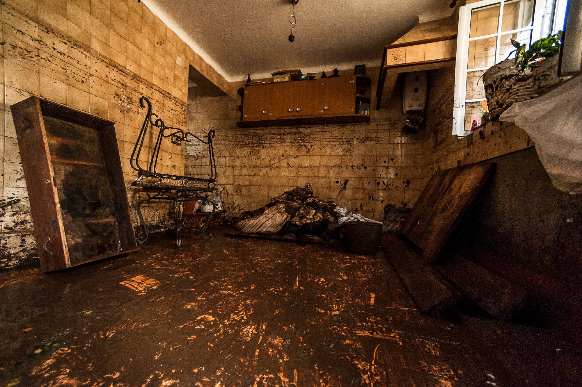 A section of Maria de Lurdes house after dirt and mud was removed showing how high the flood waters reached. Airmen from the 65th Operations Support Squadron and other units from Lajes Field volunteered to remove water and mud from homes and businesses following severe rain and flooding in Porto Judeu, Azores, Mar. 15, 2013. Roughly 30 homes were damaged from the flooding.  (Photo by Lucas Silva)
