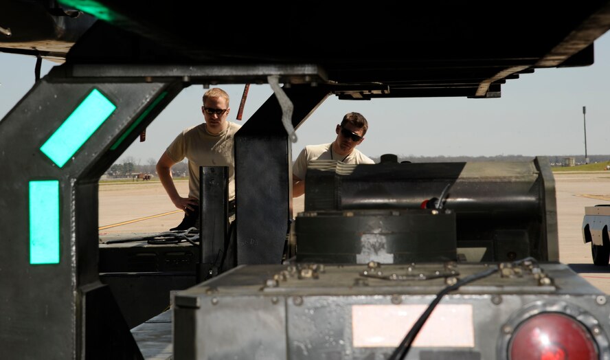 Staff Sgts. Daniel Santell, left, and Christopher Ueckler, 2nd Maintenance Squadron Weapons Standardization, position an MHL-96 trailer under a B-52H Stratofortress wing pylon on Barksdale Air Force Base, La., March 15. The Airmen recently participated in an exercise that reinforced munitions Airmen's skills in loading and unloading munitions quickly and effectively in a combat situation. (U.S. Air Force photo/Airman 1st Class Andrew Moua)