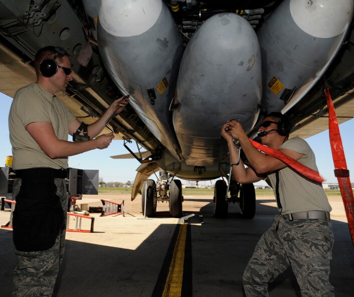 Staff Sgt. Daniel Santell, left, and Senior Airman Gildo Pena-Lopez, both from the 2nd Maintenance Group Weapons Standardization, de-arm inert AGM-86B cruise missiles during a training exercise on Barksdale Air Force Base, La., March 15. The exercise reinforced munitions Airmen's skills in loading and unloading munitions quickly and effectively in a combat situation. (U.S. Air Force photo/Airman 1st Class Andrew Moua)