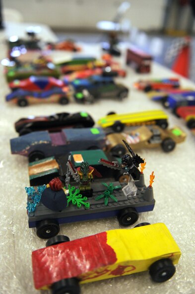 More than 50 racing cars were entered into this year's Cub Scout Pinewood Derby during the March 16, 2013, event held in the 100th Civil Engineering Squadron Fire Department at RAF Mildenhall, England.  The cars are made out of pine wood. This year's car models ranged from Lego creations to the traditional pinewood blocks or balsa wood and wheels. One of the fastest cars of the day was the double-decker bus and the Batmobile. (U.S. Air Force photo by Tech. Sgt. Stacia Zachary/Released)