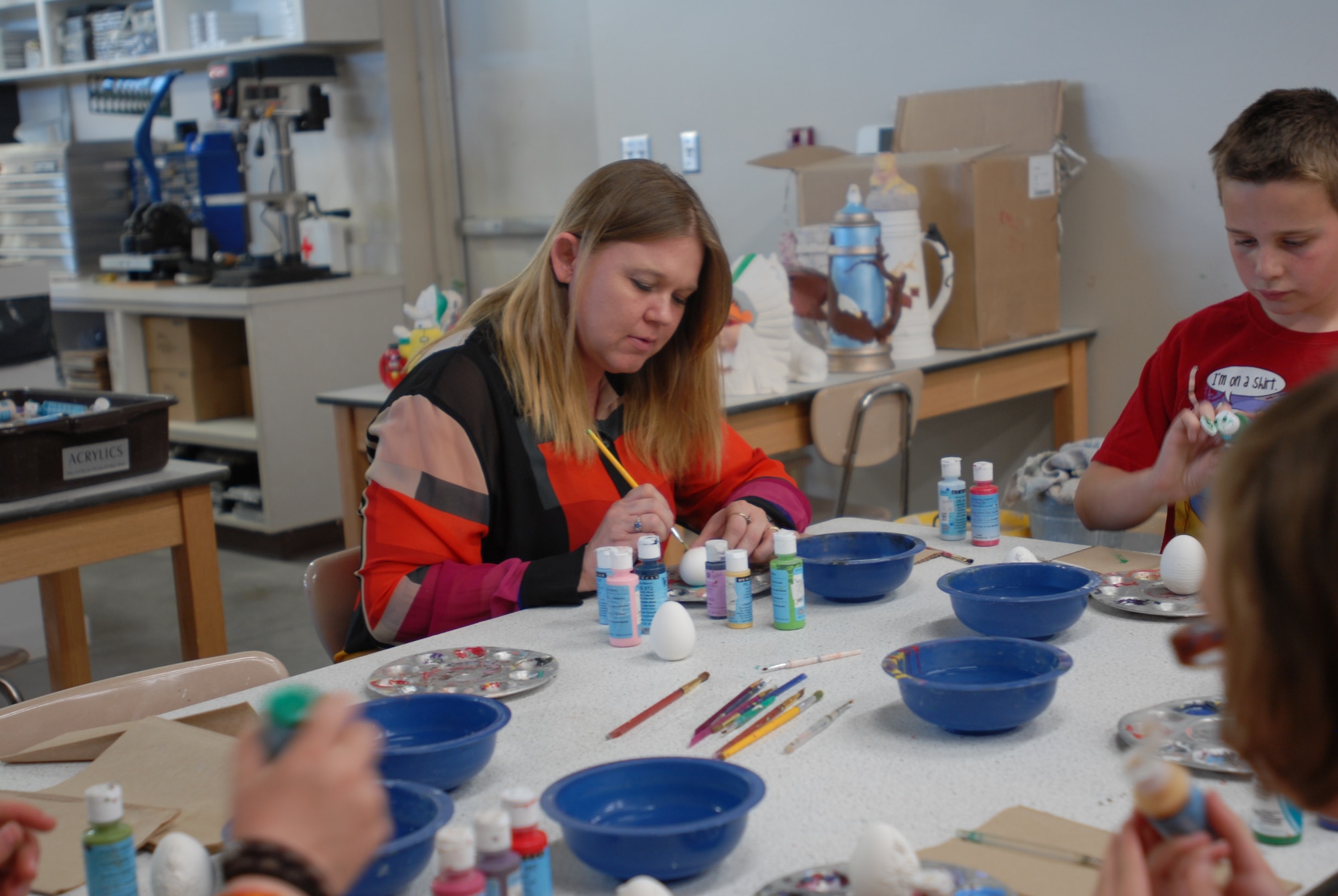 GOODFELLOW AIR FORCE BASE, Texas – Shandy Scott, 17th Force Support Squadron director of the youth programs, paints a ceramic egg for her daughter March 15 at the Arts and Craft center here. The Arts and Crafts center offers the introduction of pottery as well as ceramic painting classes. (U.S. Air Force photo/ Airman 1st Class Breonna Fields)