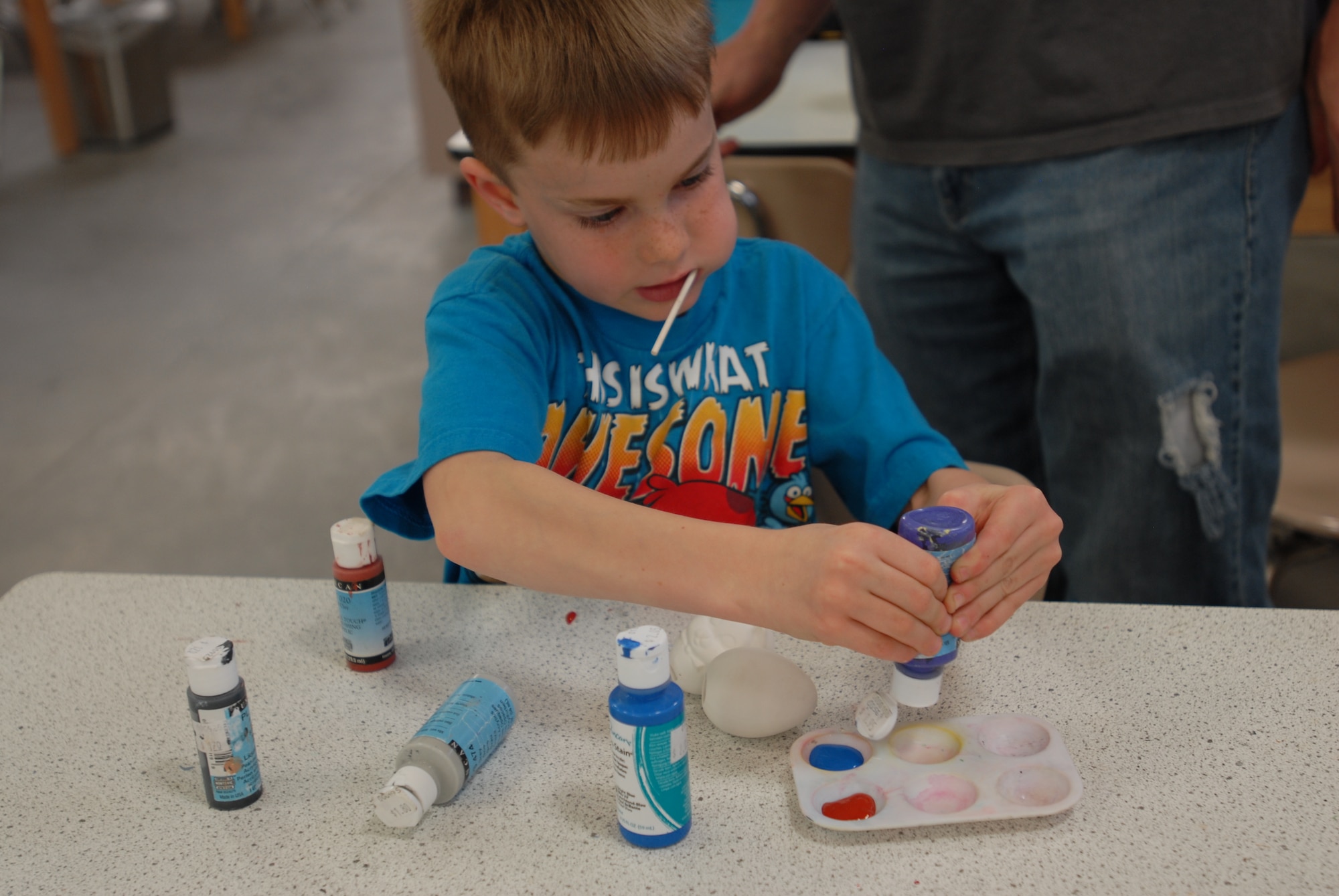 GOODFELLOW AIR FORCE BASE, Texas – Zachary Lord prepares his paint tray before painting his eggs March 15 at the Arts and Craft Center here. The Arts and Crafts center offers the introduction of pottery as well as ceramic painting classes. (U.S. Air Force photo/ Airman 1st Class Breonna Fields)