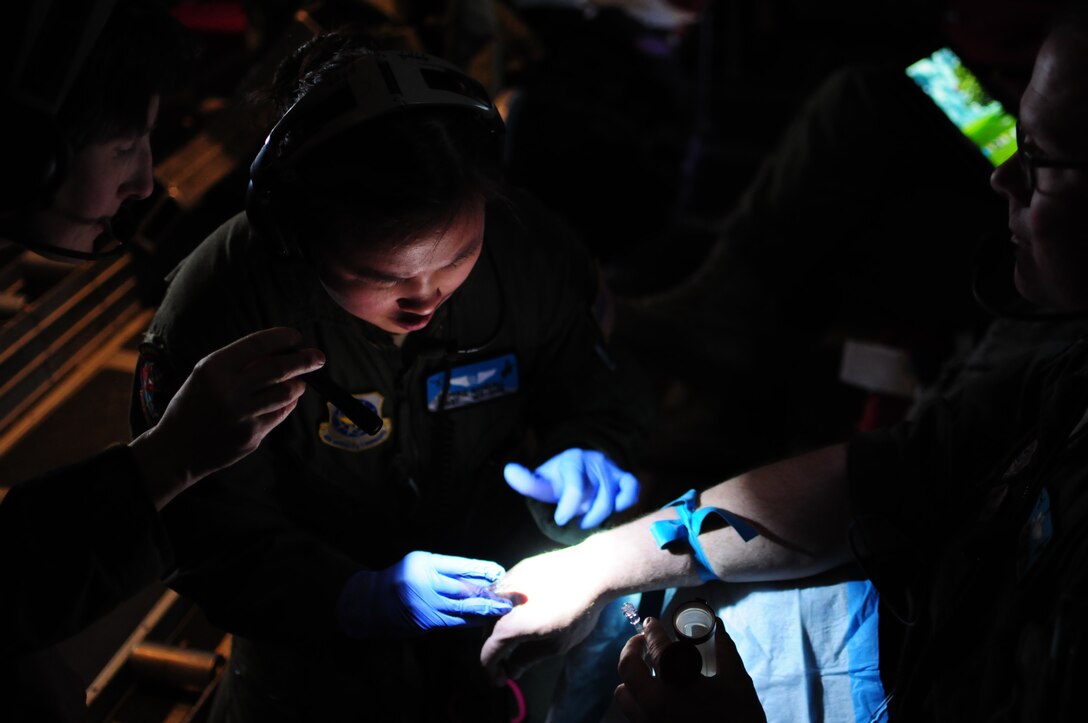 Wyoming Air National Guard Staff Sgt. Daphne Randall, 187th Aeromedical Evacuation Squadron medical technician, administers an IV during in-flight training March 2, in Cheyenne, Wyo. Airmen of the 187th AES are comprised of flight nurses and medical technicians trained to support deployed and humanitarian medical missions. (U.S. Air Force photo/Tech. Sgt. Natalie Stanley)


