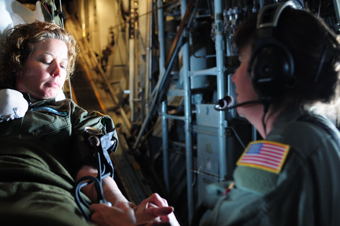 Wyoming Air National Guard Senior Master Sgt. Julie Swearingin, noncommissioned officer in charge of in-flight training, administers medical care to 1st Lt. Leigh Miller, flight nurse, during an in-flight training mission March 2, 2013, in Cheyenne, Wyo. Airmen of the 187th AES are comprised of flight nurses and medical technicians trained to support deployed and humanitarian medical missions. (U.S. Air Force photo/Tech. Sgt. Natalie Stanley)


