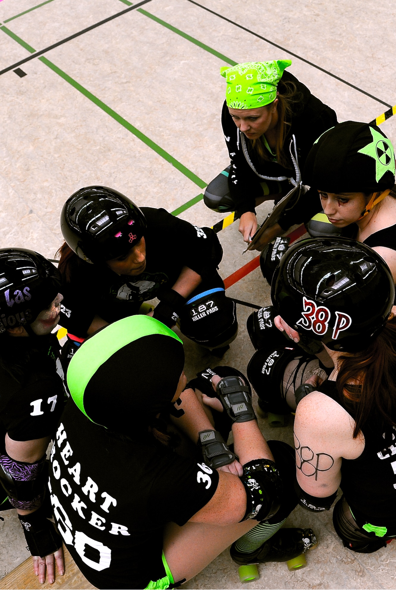 Roller Girls of the Apocalypse roller derby team talk to each other about different strategies during a bout, March 9, 2013, Kaiserslautern Germany. The team, originally the K-Town Derby Girls, is a non-profit sports club for anyone looking for a little recreation. (U.S. Air Force photo/Airman 1st Class Hailey Haux)