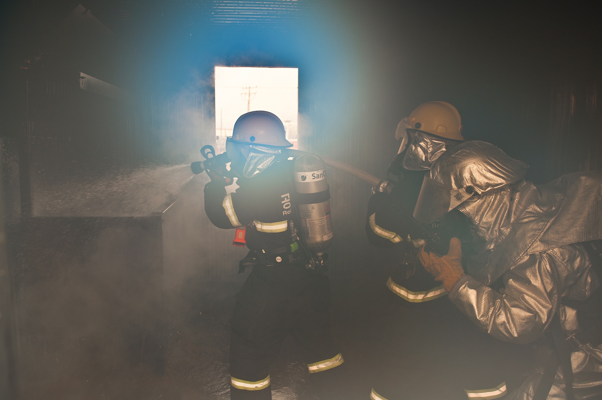 Firefighters with the 8th Civil Engineer Squadron and the Republic of Korea air force 38th Fighter Group put out a fire during exercise Beverly Midnight 13-2 at Kunsan Air Base, Republic of Korea, Mar. 18, 2013. The fire was part of a training scenario designed to evaluate the capabilities of the firefighters. (U.S. Air Force photo by Staff Sgt. Jonathan Fowler/Released)