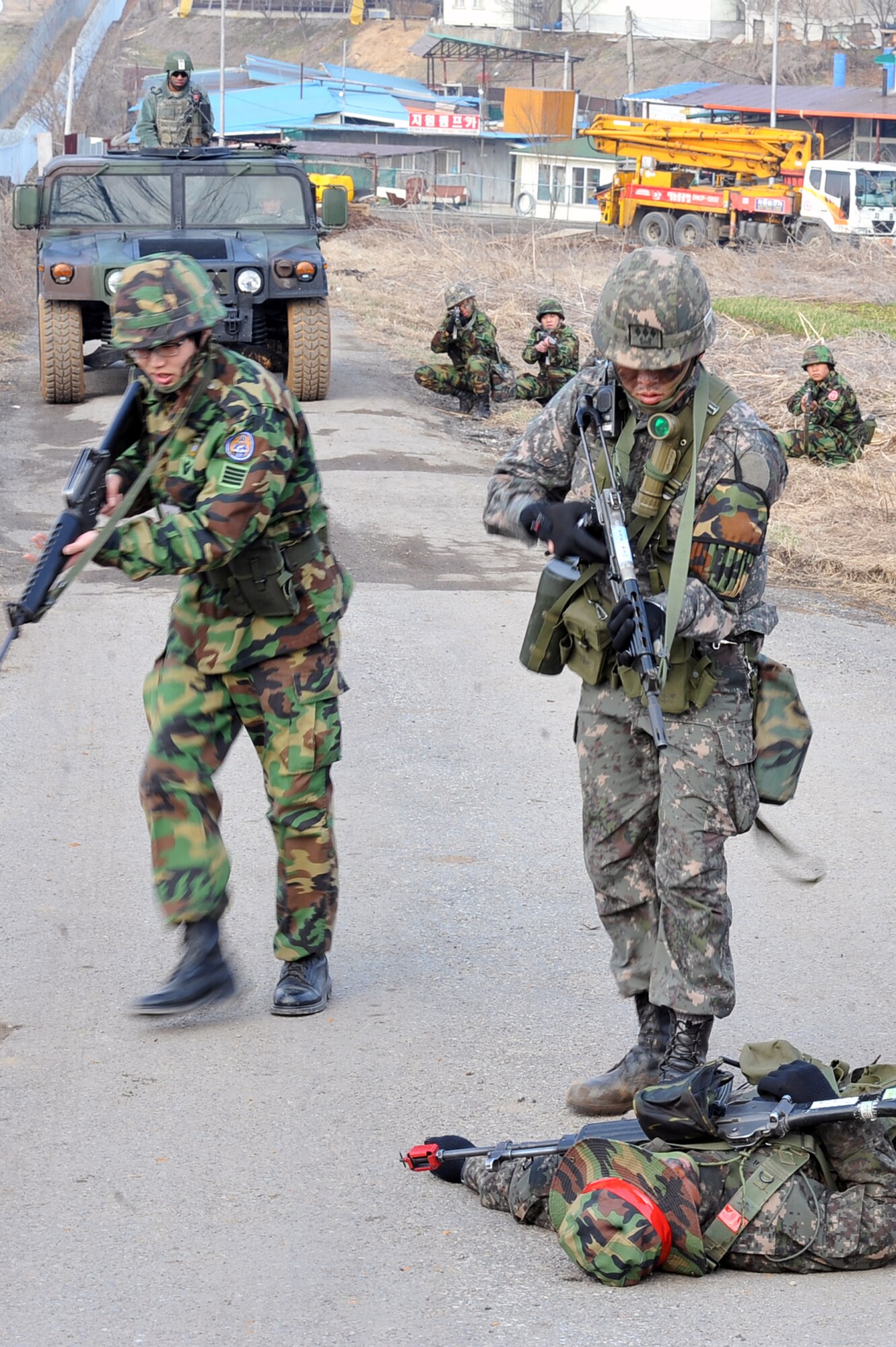 Republic of Korea Army soldiers take out opposing forces with the help of 51st Security Forces Squadron defenders during a ROK Army joint exercise near Osan Air Base March 15, 2013.  Nearly 30 ROK Army soldiers assigned to the 3rd and 4th Battalions of the 169th Infantry Regiment worked with 13 Osan Airmen during the ROK Army exercise.  (U.S. Air Force photo/Senior Airman Alexis Siekert)
