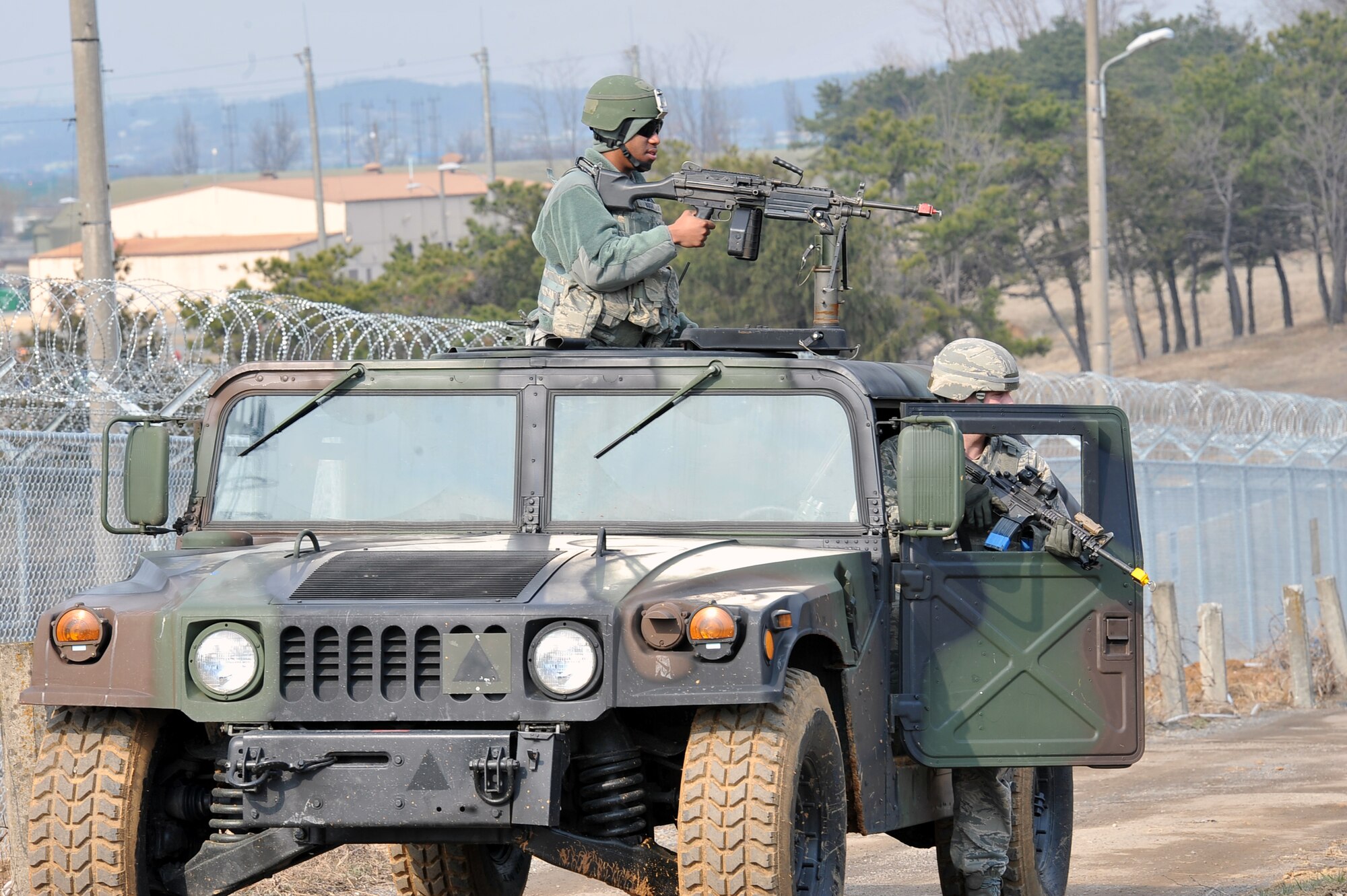 Airman 1st Class David Bush (left), 51st Security Forces Squadron defender, and a fellow defender react to enemy contact as part of a Republic of Korea Army exercise near Osan Air Base March 15, 2013.  Security forces defenders are trained and equipped to be on their toes at all times during outside-the-wire missions.  (U.S. Air Force photo/Senior Airman Alexis Siekert)