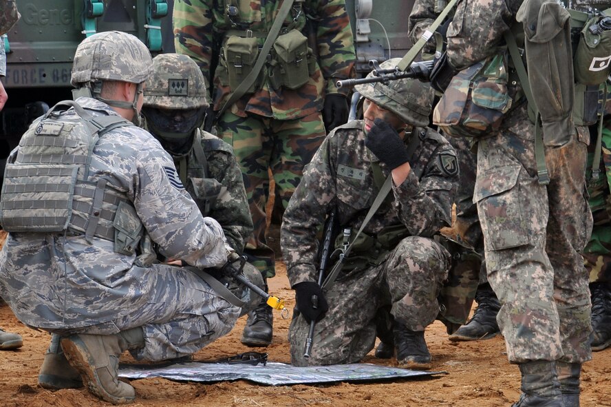Tech. Sgt. Raymond Cantrell (left), 51st Security Forces Squadron defender, discusses plan of battle with the Republic of Korea Army forces during a ROK Army exercise near Osan Air Base March 15, 2013. Prepositioning of friendly forces to counteract the enemy is key in air base defense operations. (U.S. Air Force photo/Senior Airman Alexis Siekert)