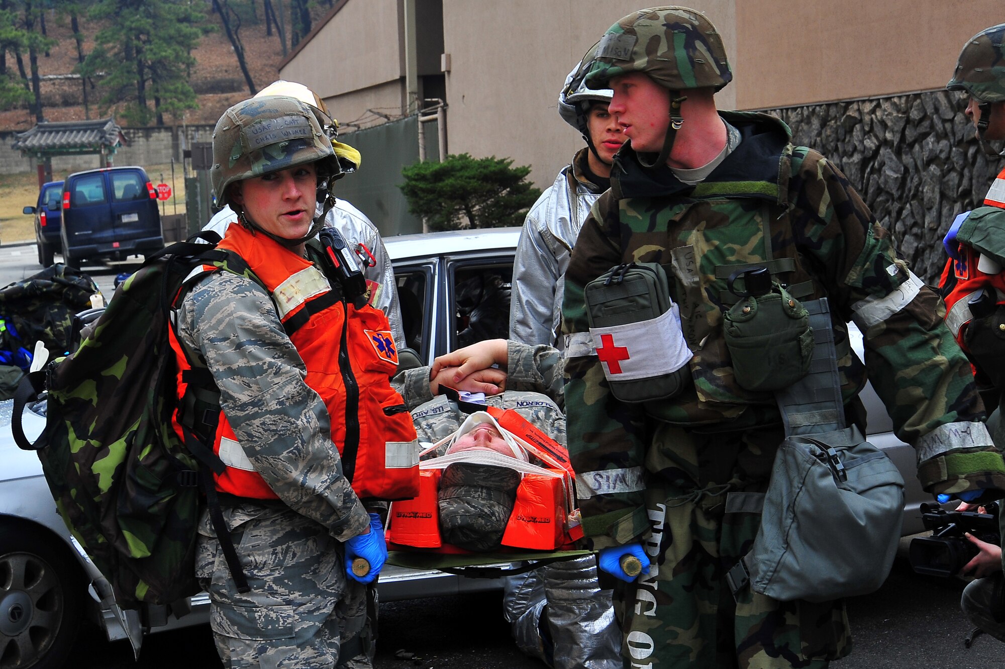 Capt. Christopher Widmer (left),51st  Dental Squadron general dentist, and Airman 1st Class Timothy Mason, 51st Medical Operations Squadron medical technician, help carry an injured passenger to an ambulance during a mass casualty scenario during Operational Readiness Exercise Beverly Midnight 13-02 at Osan Air Base, Republic of Korea, March 18, 2013.  Osan participates in these exercises so Airmen can demonstrate their capabilities and ability to perform in heightened awareness situations.  (U.S.  Air Force photo/Staff Sgt. Emerson Nuñez)