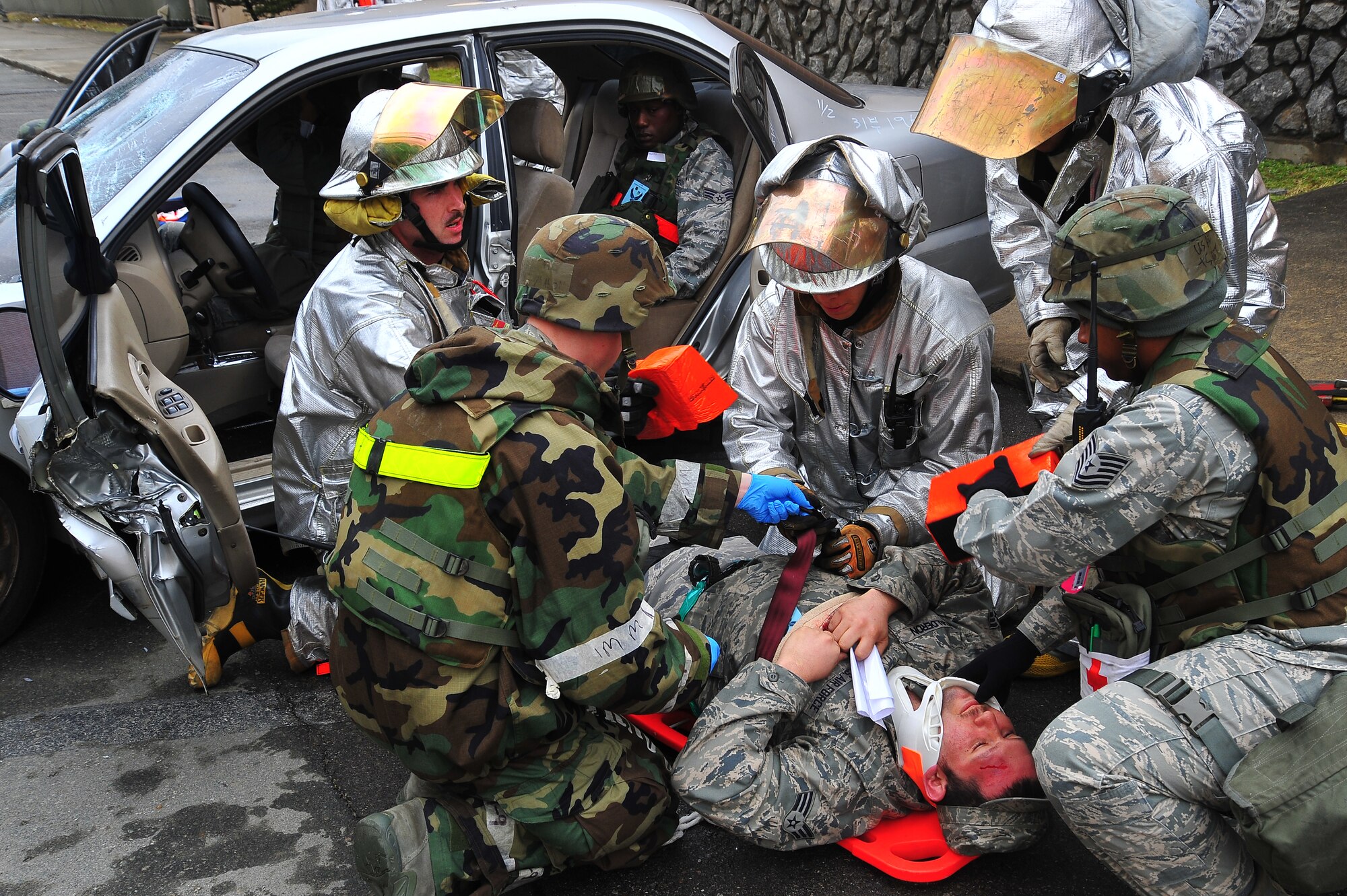 First responders strap down Senior Airman Gilbert Calderon, 51st Aircraft Maintenance Squadron weapons team technician, onto a gurney during a mass casualty scenario during Operational Readiness Exercise Beverly Midnight 13-02 at Osan Air Base, Republic of Korea, March 18, 2013.  This is Osan’s third simulated wartime contingency exercise in 2013 that will test the base’s ability to defend and execute the mission in a heightened state of readiness.  (U.S.  Air Force photo/Staff Sgt. Emerson Nuñez)