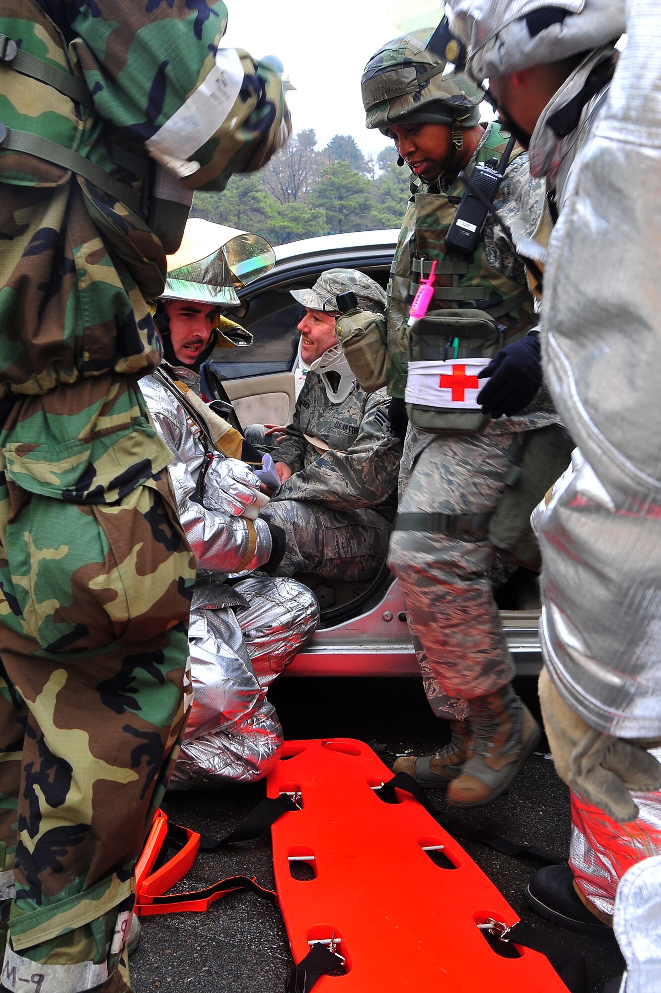 First responders help Senior Airman Gilbert Calderon, 51st Aircraft Maintenance Squadron weapons team technician, out of a vehicle during a mass casualty scenario during Operational Readiness Exercise Beverly Midnight 13-02 at Osan Air Base, Republic of Korea, March 18, 2013.  Osan Airmen participate in OREs to maintain proficiency for wartime conditions.  (U.S.  Air Force photo/Staff Sgt. Emerson Nuñez)