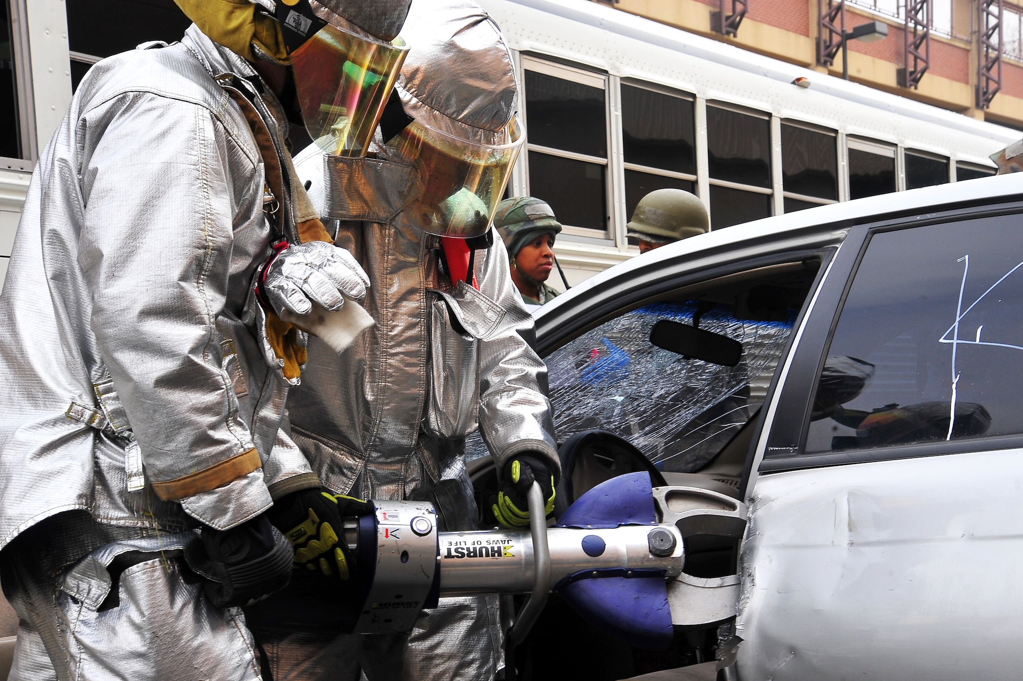 Two firefighters with the 51st Civil Engineer Squadron cuts off the hinges of a vehicle in a mass casualty car accident exercise during Operational Readiness Exercise Beverly Midnight 13-02 on Osan Air Base, Republic of Korea, March 18, 2013.  Osan Airmen are in the third simulated wartime contingency exercise executed in 2013 that will test the base's ability to defend and execute the mission in a heightened state of readiness.  (U.S.  Air Force photo/Staff Sgt. Emerson Nuñez)
