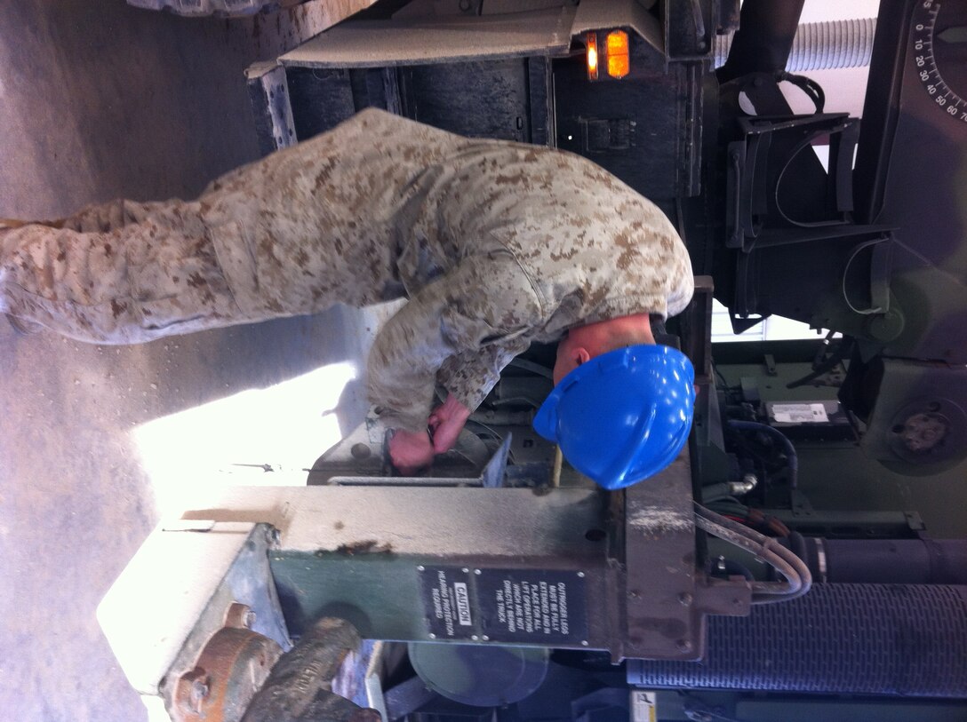 Lance Corporal Stevie R. Mehalic, 1st Radio Battalion practices unstowing and stowing the material handling crane on the AMK36 wrecker at Ft. Leonard Wood, MO while attending Vehicle Recovery Operator Course 3-12. This is one of the first events students learn in the course prior to becoming certified as a 3536 NMOS (Vehicle Recovery Operator).