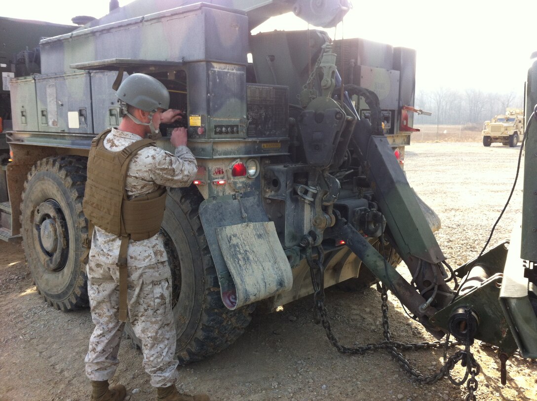 Lance Corporal Micheal T. Morin, CLB-6 is conducting practical application of lifting a towed load with an AMK36 wrecker prior to operating with a towed load at Ft. Leonard Wood, MO while attending Vehicle Recovery Operator Course 3-12. This is one of the first events that students learn in the course prior to becoming certified as a 3536 NMOS (Vehicle Recovery Operator). 