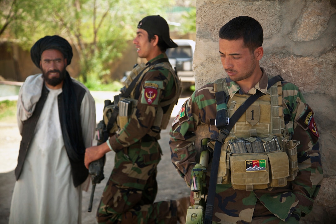 An Afghan national army special forces member maintains security while ...