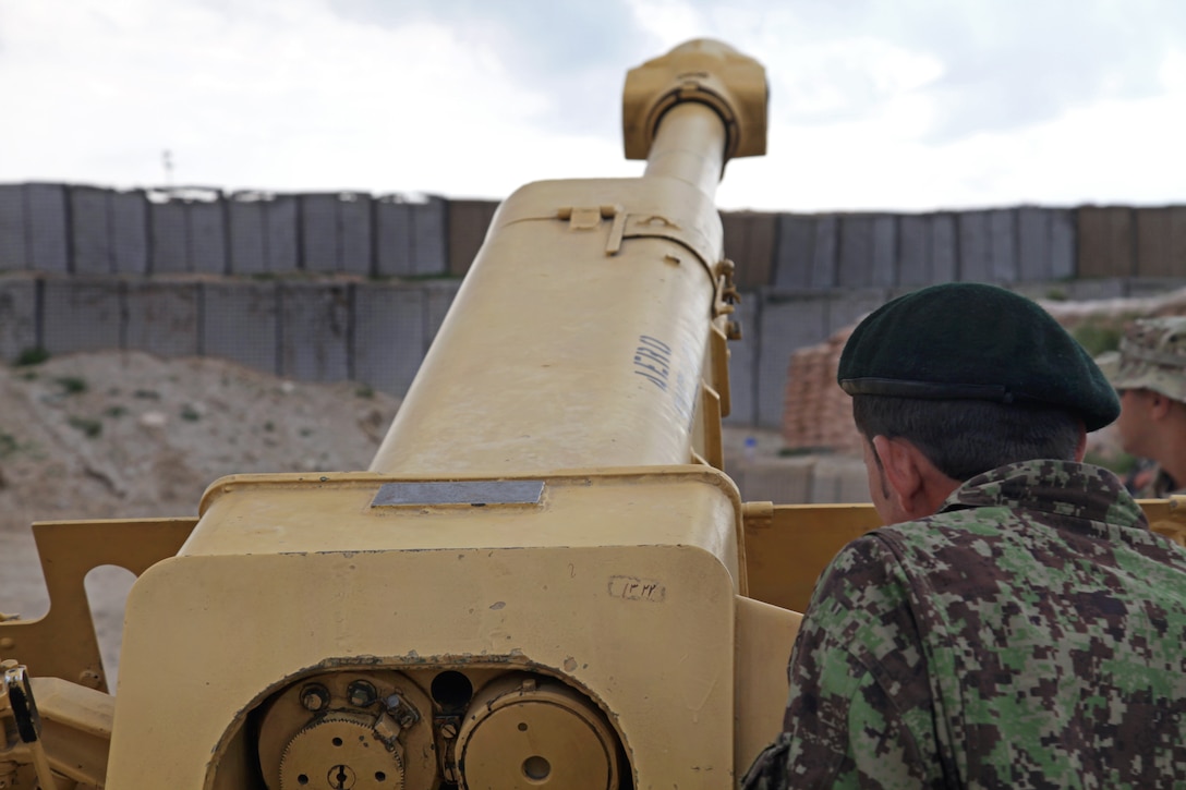 An Afghan soldier looks down the tube of a D-30 howitzer on Forward Operating Base Mehtar Lam in Afghanistan’s Laghman province, March 12, 2013.