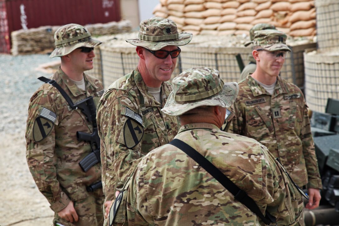 U.S. soldiers speak to each other about their training on a D-30 howitzer on Forward Operating Base Mehtar Lam in Afghanistan’s Laghman province, March 12, 2013.