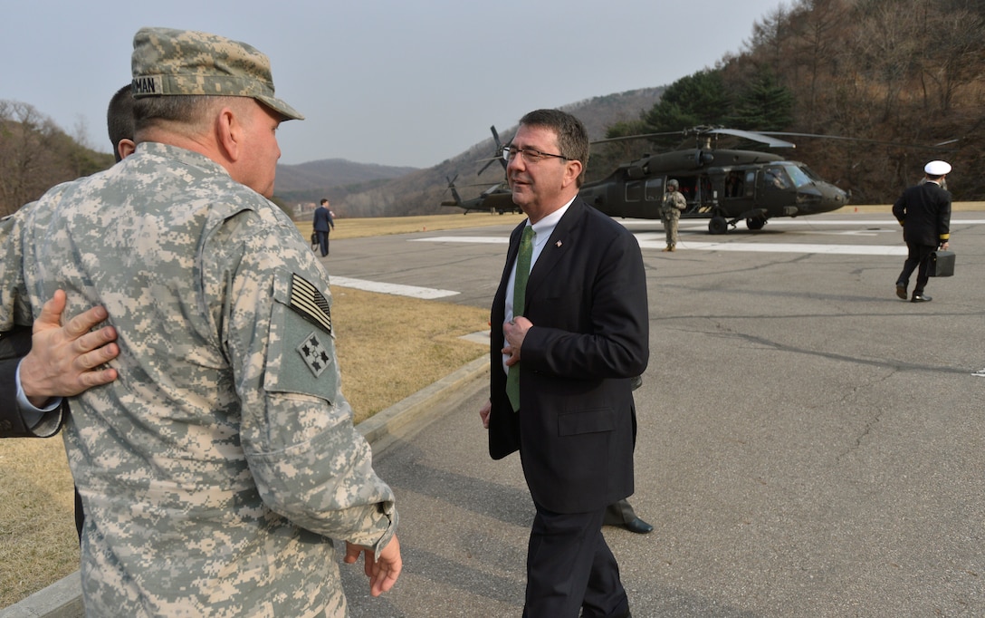 U.S. Deputy Defense Secretary Ash Carter, right, offers his thanks to U.S. Army Gen. James D. Thurman, commander of Combined Forces Command and U.S. Forces Korea, as he prepares to depart Command Post Tango near Seoul, South Korea, March 18, 2013. 