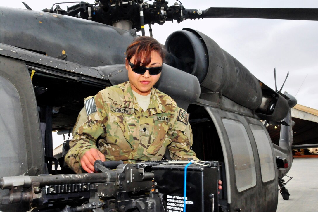 U.S. Army Spc. Shaina Joseph mounts her M240B machine gun aboard a UH-60 Black Hawk helicopter on Jalalabad Airfield in Afghanistan's Nangarhar province, March 13, 2013. Joseph, a chemical, biological, radiological and nuclear specialist, is assigned to the 101st Airborne Division's Company C, 3rd Battalion, 501st Combat Aviation Brigade, 1st Brigade Combat Team.