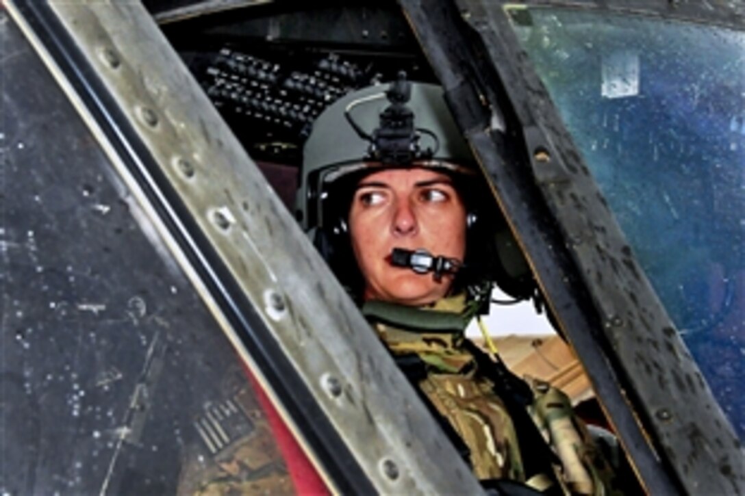 U.S. Army Chief Warrant Officer 2 Bethany Bump conducts her pre-flight routine in a UH-60 Black Hawk helicopter and checks with her crew chief before a mission on Jalalabad Airfield in Afghanistan's Nangarhar province, March 13, 2013. Bump, a helicopter pilot, is assigned to the 101st Airborne Division's Company C, 3rd Battalion, 501st Combat Aviation Brigade, 1st Brigade Combat Team. 