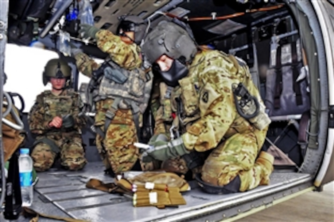 U.S. Army Pfc. Laci Lognion, right, inventories her medical equipment while U.S. Army Capt. Ivonne Cartagena, center, adjusts medical items during a pre-flight exercise on Jalalabad Airfield in Afghanistan's Nangarhar province, March 13, 2013. Lognion, a flight paramedic, and Cartagena, a critical care nurse, are assigned to the 101st Airborne Division's Company C, 2nd Battalion, 149th General Support Aviation Brigade, 1st Brigade Combat Team. 