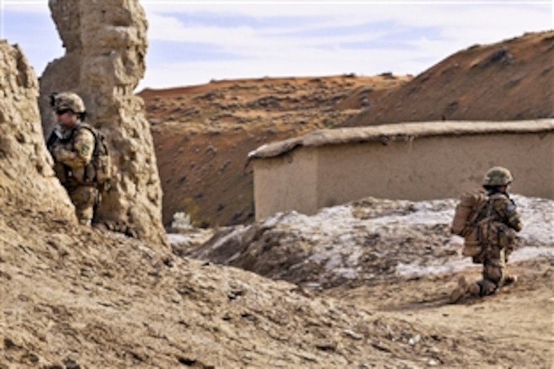 U.S. female soldiers secure an Afghan compound while other soldiers meet with Afghan elders in the Spin Boldak district in Afghanistan's Kandahar province, March 3, 2013. The soldiers are assigned to the 2nd Infantry Division's Female Engagement Team 6, 2nd Battalion, 23rd Infantry Regiment, and 519th Military Intelligence Battalion.