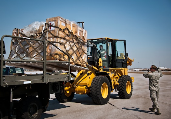 Staff Sgt. Robby Harrison, of the 96th Logistics Readiness Squadron, directs the loader back after picking up some maintenance equipment from a C-5 Galaxy March 14 at Eglin Air Force Base, Fla.  The Airmen unloaded approximately 103,165 pounds of maintenance equipment for an F-16 unit participating in a weapons system evaluation program March 18-22.  (U.S. Air Force photo/Samuel King Jr.)