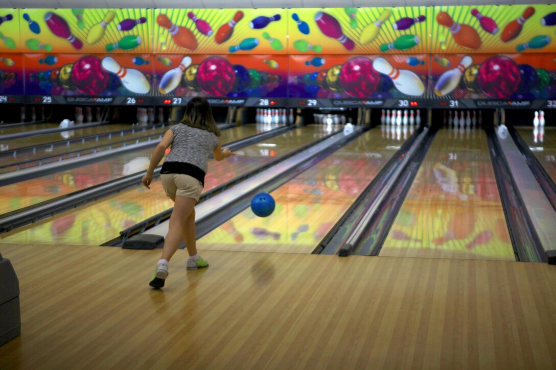 A Marine spouse throws a bowling ball down the lane during an event at the Bonnyman Bowling Center aboard Camp Lejeune, N.C., March 16, 2013. Marines and their families built relationships with each other and enjoyed pizza, beverages and snacks during the event. 