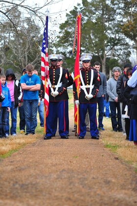 The Marine Corps Base Quantico color guard stands ready amidst a crowd of praying onlookers at the 262nd anniversary of former president James Madison's birth on March 16, 2013. Col. David Maxwell, base commander, was designated as President Barack Obamas' representative for the official wreath laying ceremony in honor of Madison, the fourth president of the United States.