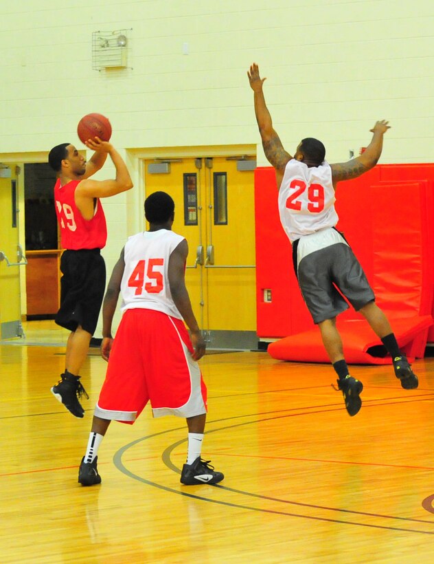 Darrel Green, a player for Marine Corps Embassy Security Group’s American League intramural basketball team, jumps up for a three-pointer on March 18, 2013, at Barber Physical Activity Center. MCESG defeated CI WPNS, 66-44.