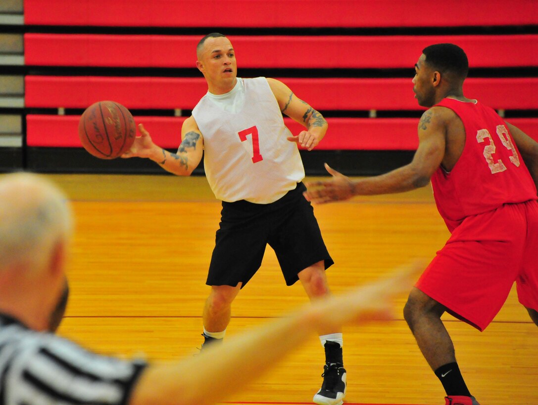 Micheal Martinet, a player for Combat Instructor Weapons’ American League intramural basketball team, makes a blind pass to a teammate on March 18, 2013, at Barber Physical Activity Center. MCESG defeated CI WPNS, 66-44.