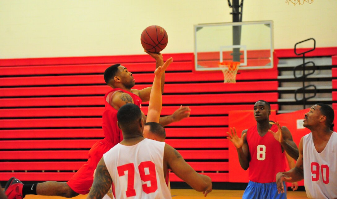 Ajawon Gadison, a player for Marine Corps Embassy Security Group’s American League intramural basketball team, goes for a layup during a game on March 18, 2013, at Barber Physical Activity Center. MCESG defeated CI WPNS, 66-44.