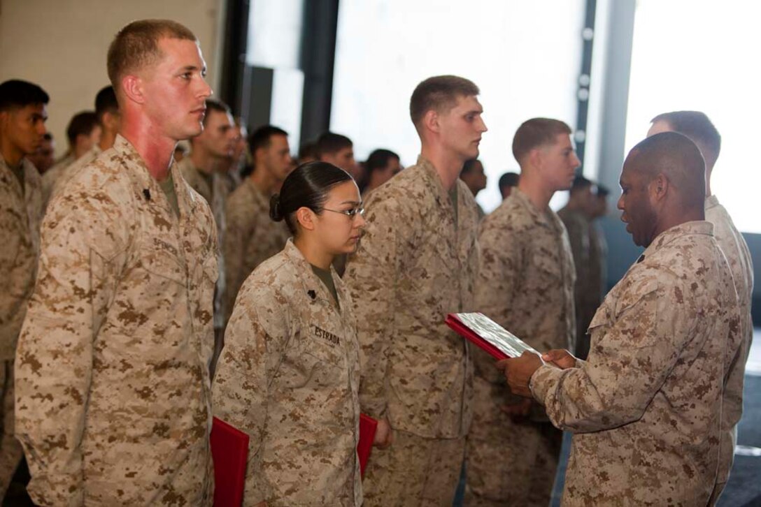 Marines with the Command Element, 15th Marine Expeditionary Unit, stand in formation during a promotion ceremony held in the hangar bay of USS Peleliu, March 1. The 15th MEU is deployed as part of the Peleliu Amphibious Ready Group as a U.S. Central Command theater reserve force, providing support for maritime security operations and theater security cooperation efforts in the U.S. 5th Fleet area of responsibility. (U.S. Marine Corps photo by Cpl. Danny L. Shaffer)